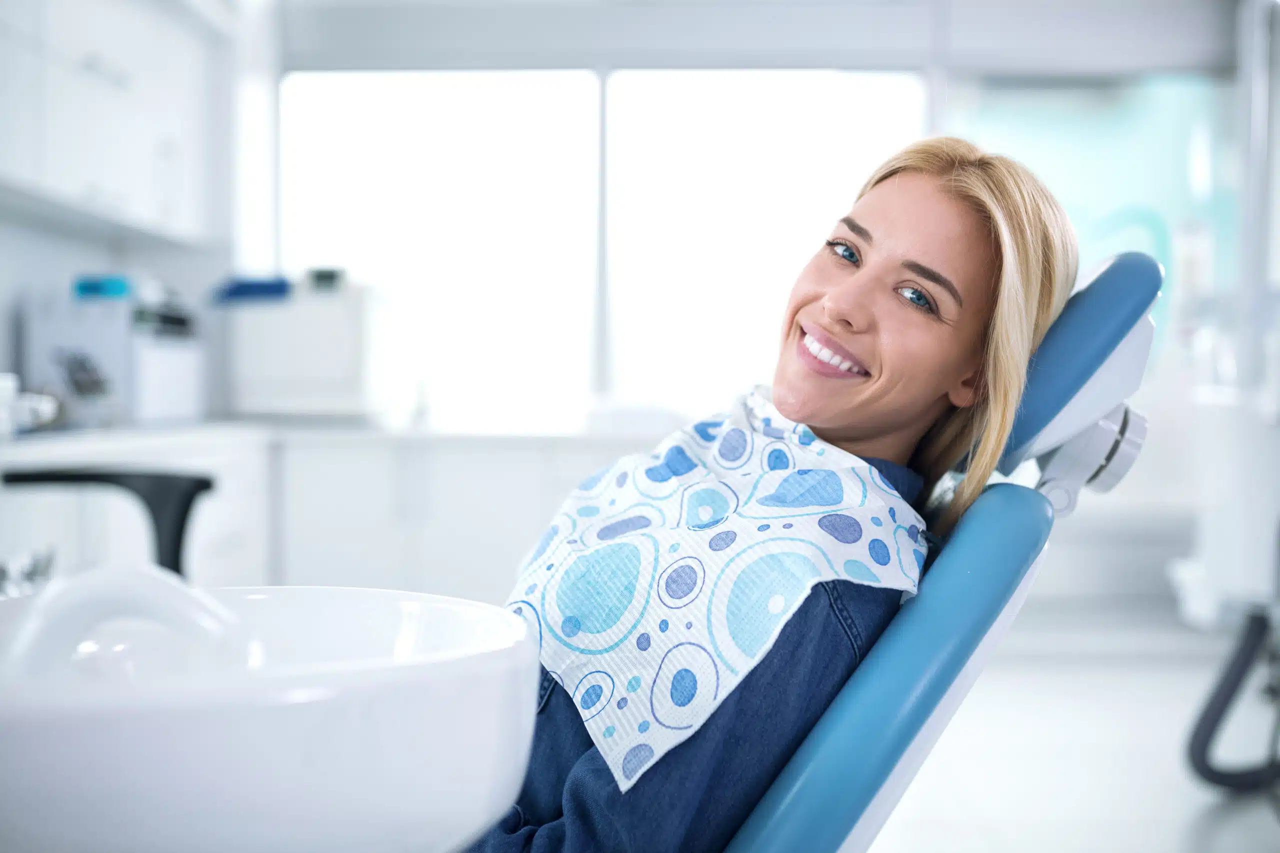 Smiling,And,Satisfied,Patient,In,A,Dental,Office,After,Treatment