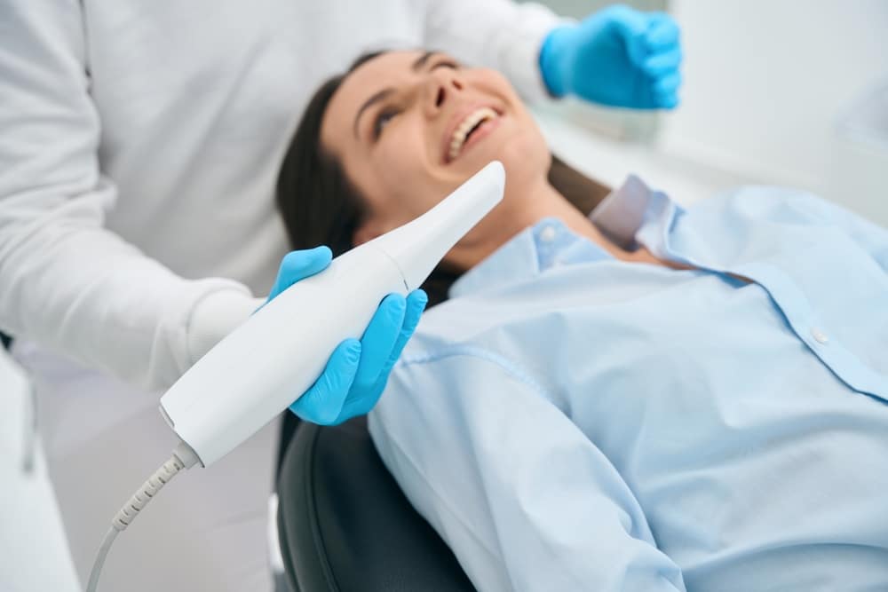 Stomatologist,In,Uniform,Taking,Intraoral,Camera,To,Examine,Mouth,Inside